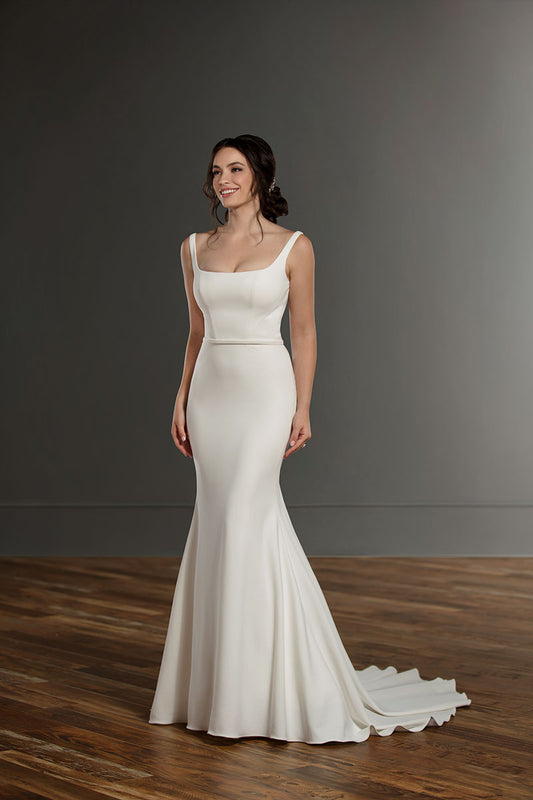 Sleek wedding gown featuring a square neckline, fitted bodice, and a flowing mermaid skirt with a subtle train, perfect for the bride seeking a modern and minimalist bridal look.