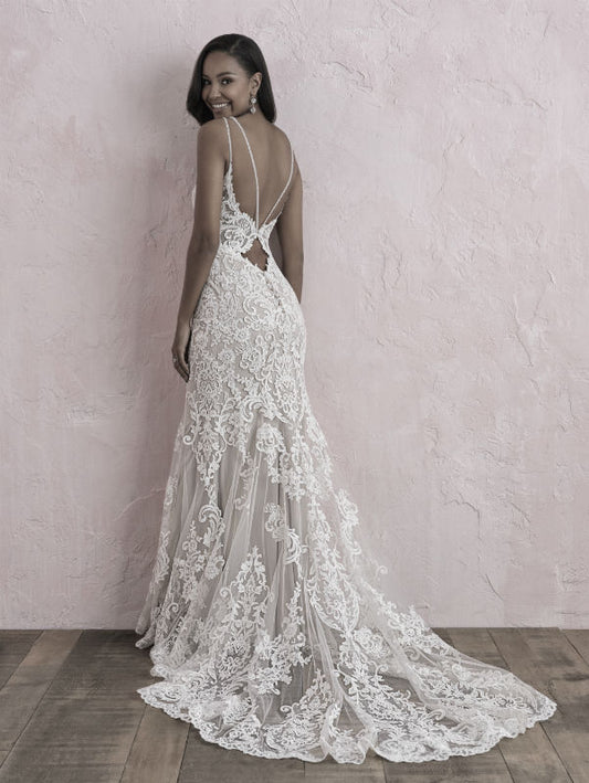 Stunning lace wedding gown featuring a captivating low back and delicate straps, creating a perfect blend of romance and sophistication for your special day.