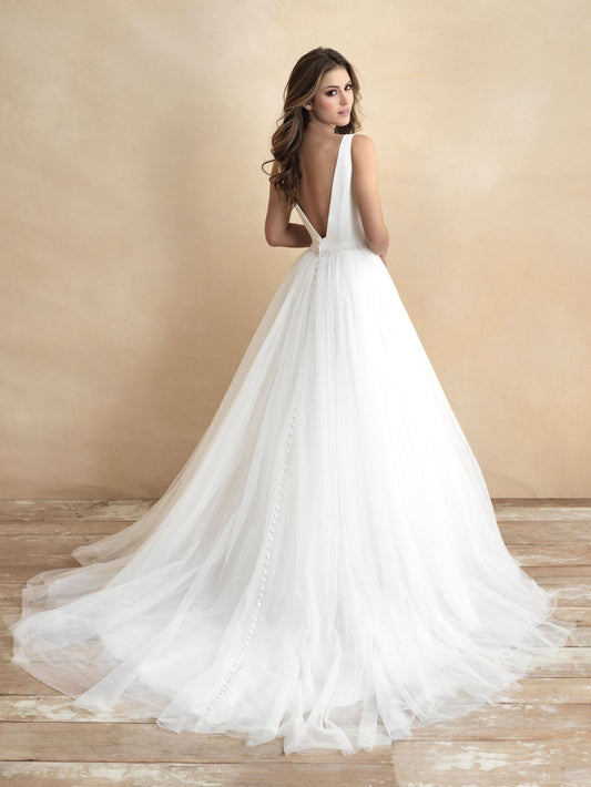 Stunning ball gown wedding dress featuring a deep V-neckline and a tulle skirt, accented with a jeweled waistband for added elegance. Ideal for brides seeking a classic yet glamorous look.