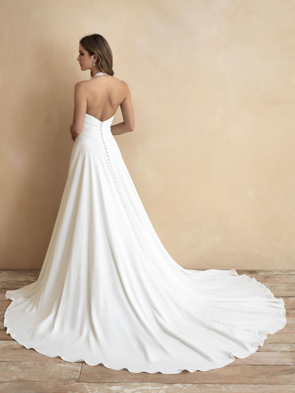 Classic halter neck wedding gown with a plunging V-neckline and flowing A-line skirt, offering a sophisticated and modern bridal look.