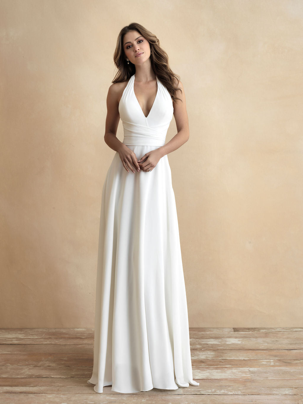 Classic halter neck wedding gown with a plunging V-neckline and flowing A-line skirt, offering a sophisticated and modern bridal look.