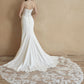 Sleek strapless wedding gown with intricate lace bodice and subtle train. Perfect for brides seeking timeless elegance and a modern silhouette.
