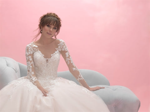 Elegant A-line wedding dress with illusion lace sleeves and a sweetheart neckline, featuring intricate floral appliqués and a flowing skirt. Ideal for brides desiring a romantic and timeless look.