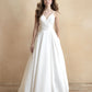 Chic A-line wedding dress with a V-neckline, pleated bodice, and subtle pockets. This timeless gown blends elegance with modern functionality, ideal for the classic yet contemporary bride.