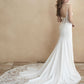 Elegant bridal gown featuring a low scoop back, delicate lace detailing on the train, and a form-fitting silhouette. Perfect for brides who desire a blend of modern sophistication and timeless romance.