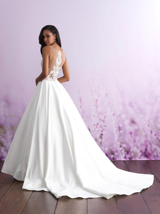 Elegant satin ball gown with a low back and lace detailing, featuring a button-down train for a timeless bridal look. Perfect for the modern bride seeking a blend of classic elegance and sophistication.