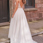 Full back view of a modern wedding gown featuring a plunging lace bodice, thin straps, and a flowing skirt with a soft train, ideal for the bride seeking a blend of elegance and contemporary style.