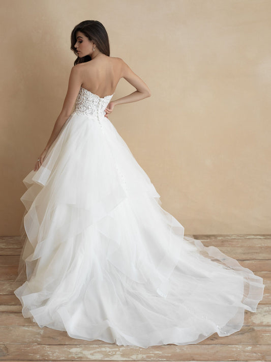 Elegant strapless ballgown wedding dress with a romantic sweetheart neckline, intricately detailed bodice, and a voluminous, layered tulle skirt. Perfect for a timeless bridal look.