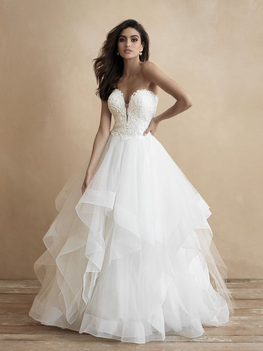 Elegant strapless ballgown wedding dress with a romantic sweetheart neckline, intricately detailed bodice, and a voluminous, layered tulle skirt. Perfect for a timeless bridal look.