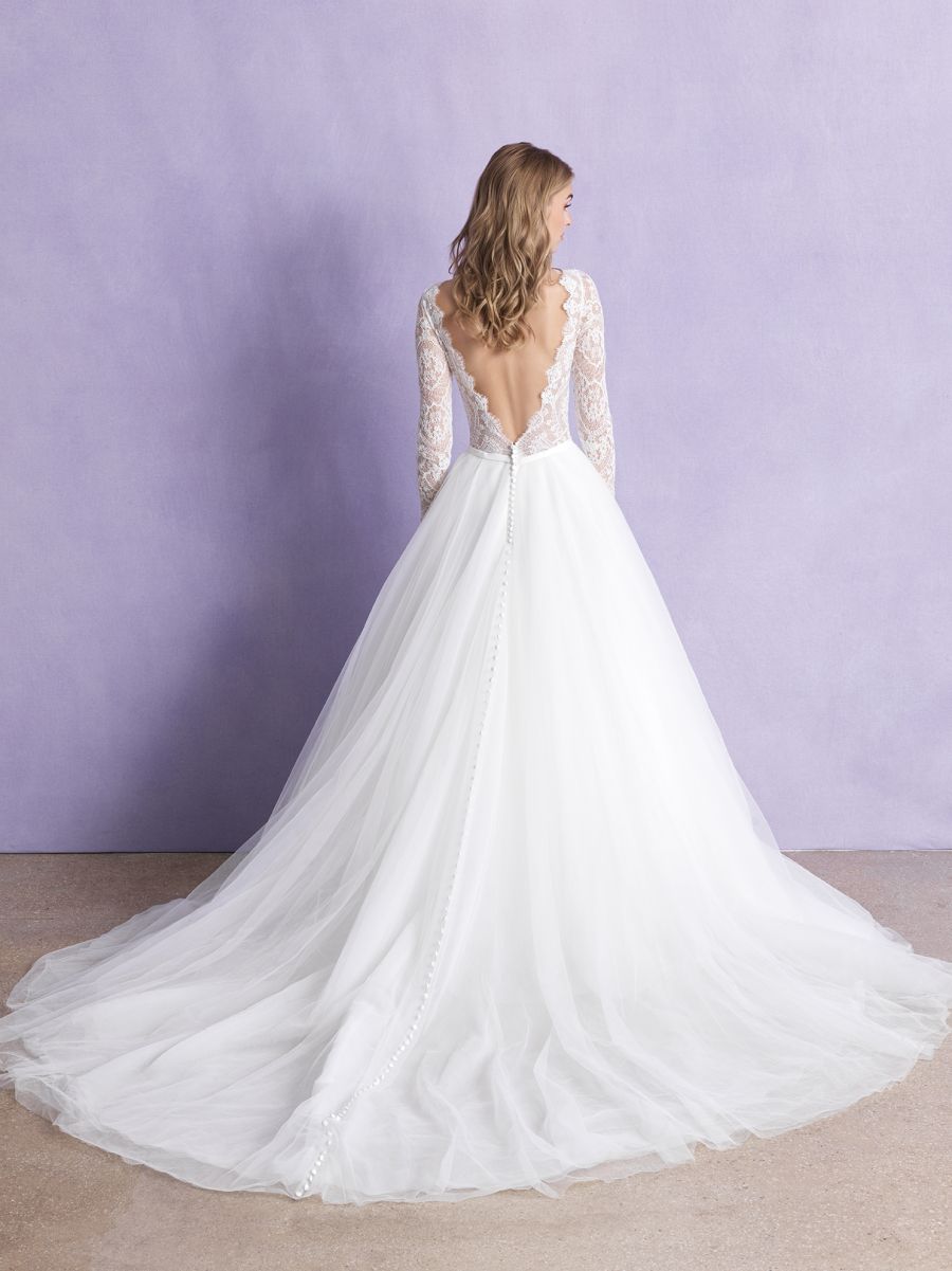 Step into timeless beauty with this lace long-sleeve bridal gown, featuring a plunging neckline and a full tulle skirt. Perfect for the bride seeking elegance and sophistication on her wedding day.