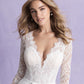Step into timeless beauty with this lace long-sleeve bridal gown, featuring a plunging neckline and a full tulle skirt. Perfect for the bride seeking elegance and sophistication on her wedding day.
