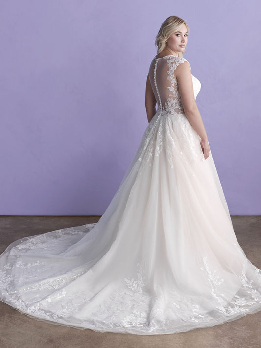 Elegant plus-size bridal gown featuring a lace-appliqué bodice, flattering V-neckline, and a flowing tulle skirt, perfect for a romantic and timeless wedding day look.