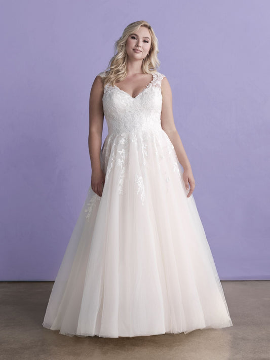 Elegant plus-size bridal gown featuring a lace-appliqué bodice, flattering V-neckline, and a flowing tulle skirt, perfect for a romantic and timeless wedding day look.