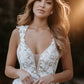 Romantic wedding dress with deep V-neck, lace bodice, and thigh-high slit, perfect for a modern bride seeking elegance and allure for her outdoor or destination wedding.