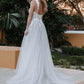 Romantic wedding dress with deep V-neck, lace bodice, and thigh-high slit, perfect for a modern bride seeking elegance and allure for her outdoor or destination wedding.